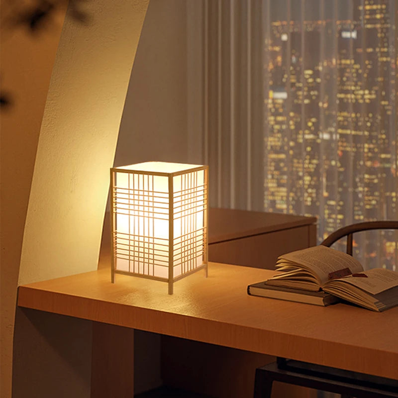 Shoji table lantern lamp shown lit on a desk