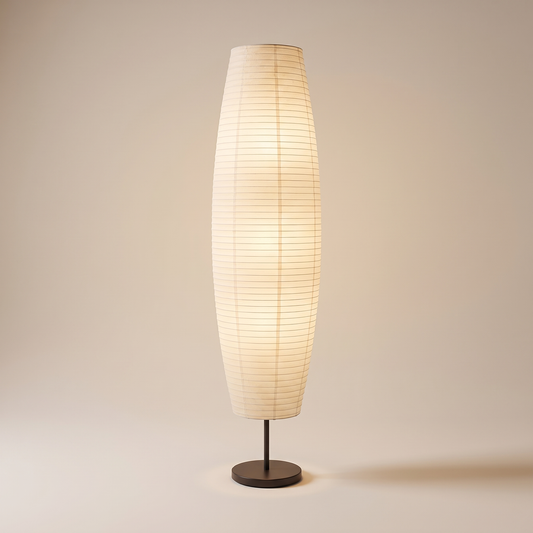 Rice paper column floor lamp, lit, on a warm neutral background