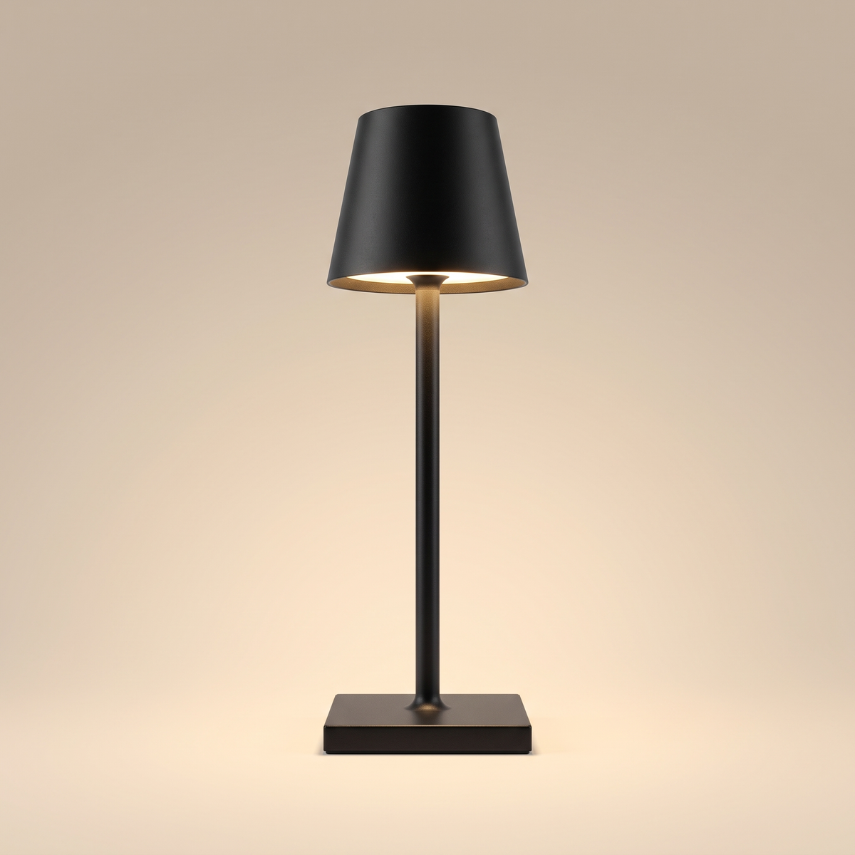 Sculptural cordless rechargeable table lamp, lit, on a warm neutral background