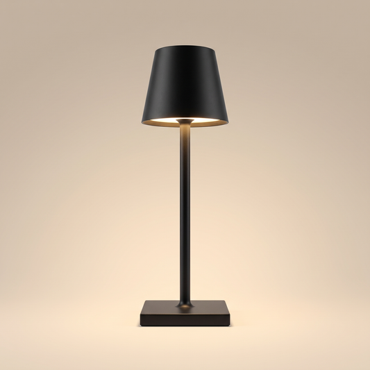 Sculptural cordless rechargeable table lamp, lit, on a warm neutral background